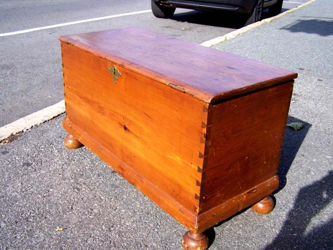 A Late 18th or early 19th century American Pine Lift-Top Child's Blanket Chest on Bun Feet